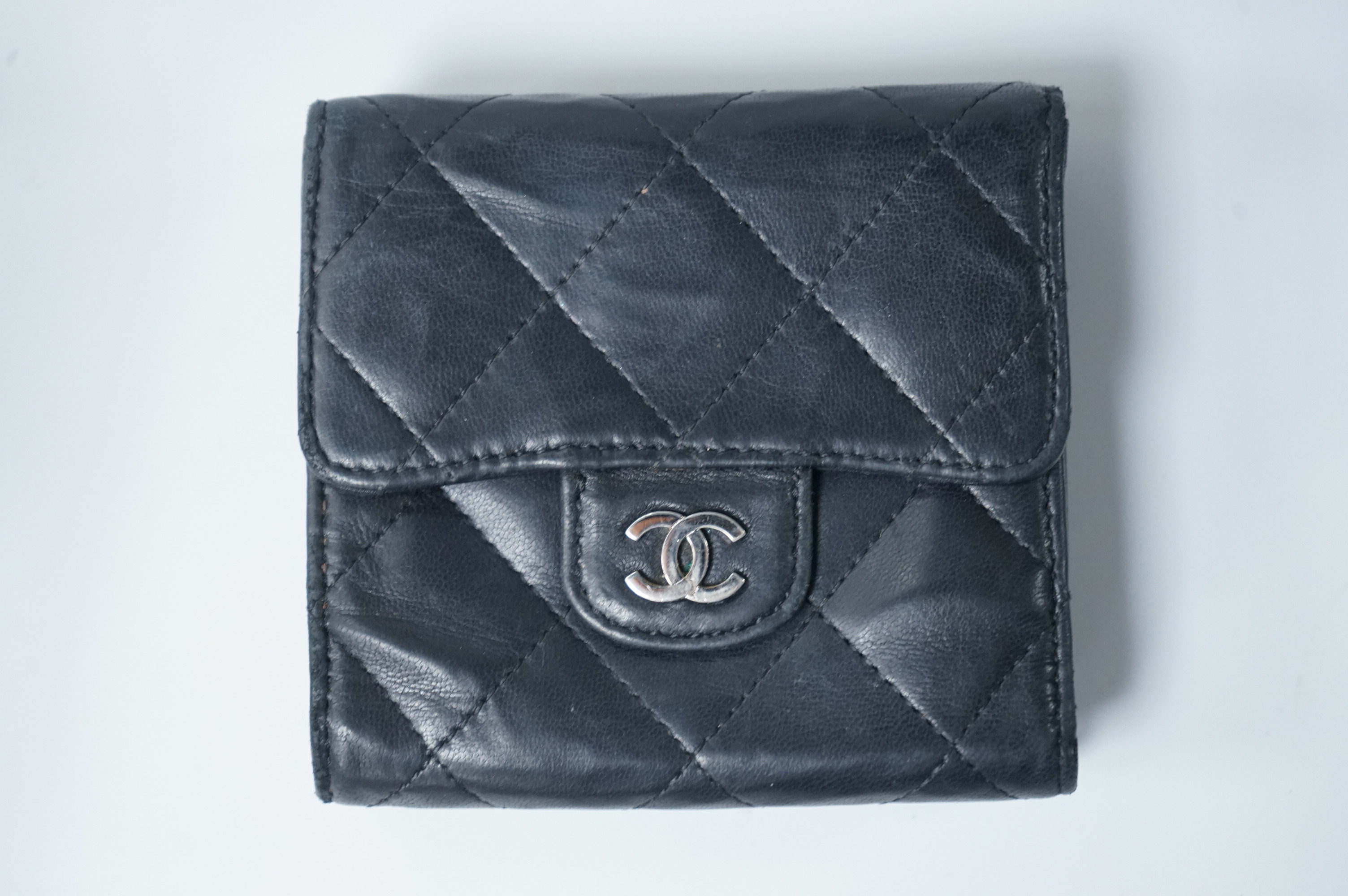 A Chanel classic double flap black leather purse, with original receipt, authenticity card numbered 10670211 and box, 10cm wide, Provenance: Purchased by the vendor in New York